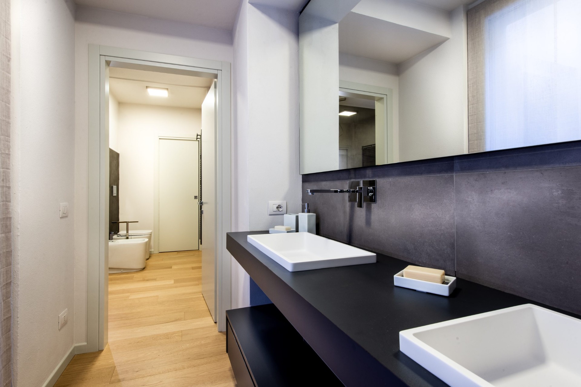 Secondo bagno con doppio lavabo e finiture minimal